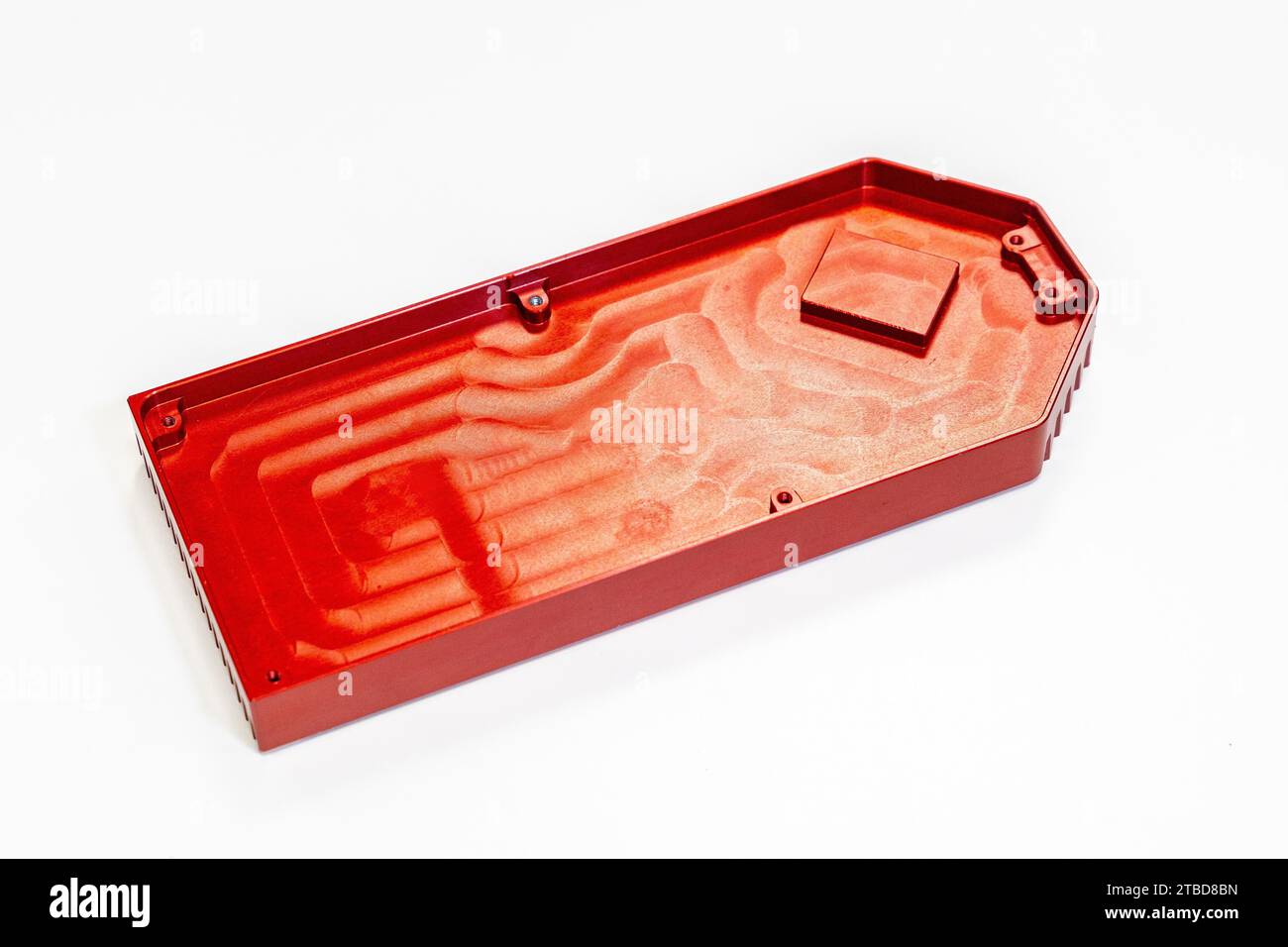 Top view of finished red metal piece ready for delivery to clients in a numerical control industry in a white background Stock Photo
