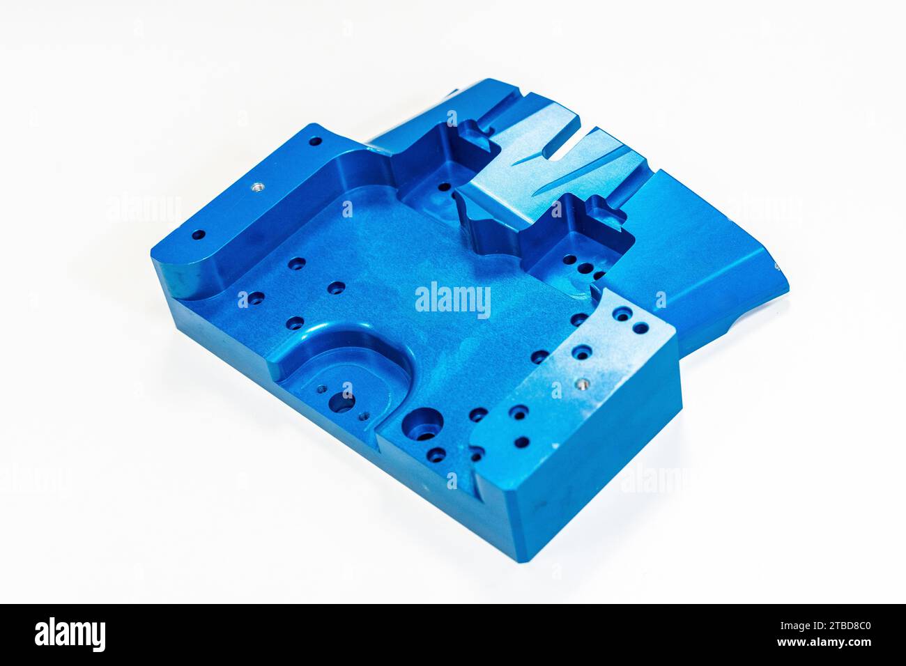 Top view of finished blue metal piece ready for delivery to clients in a numerical control industry in a white background Stock Photo