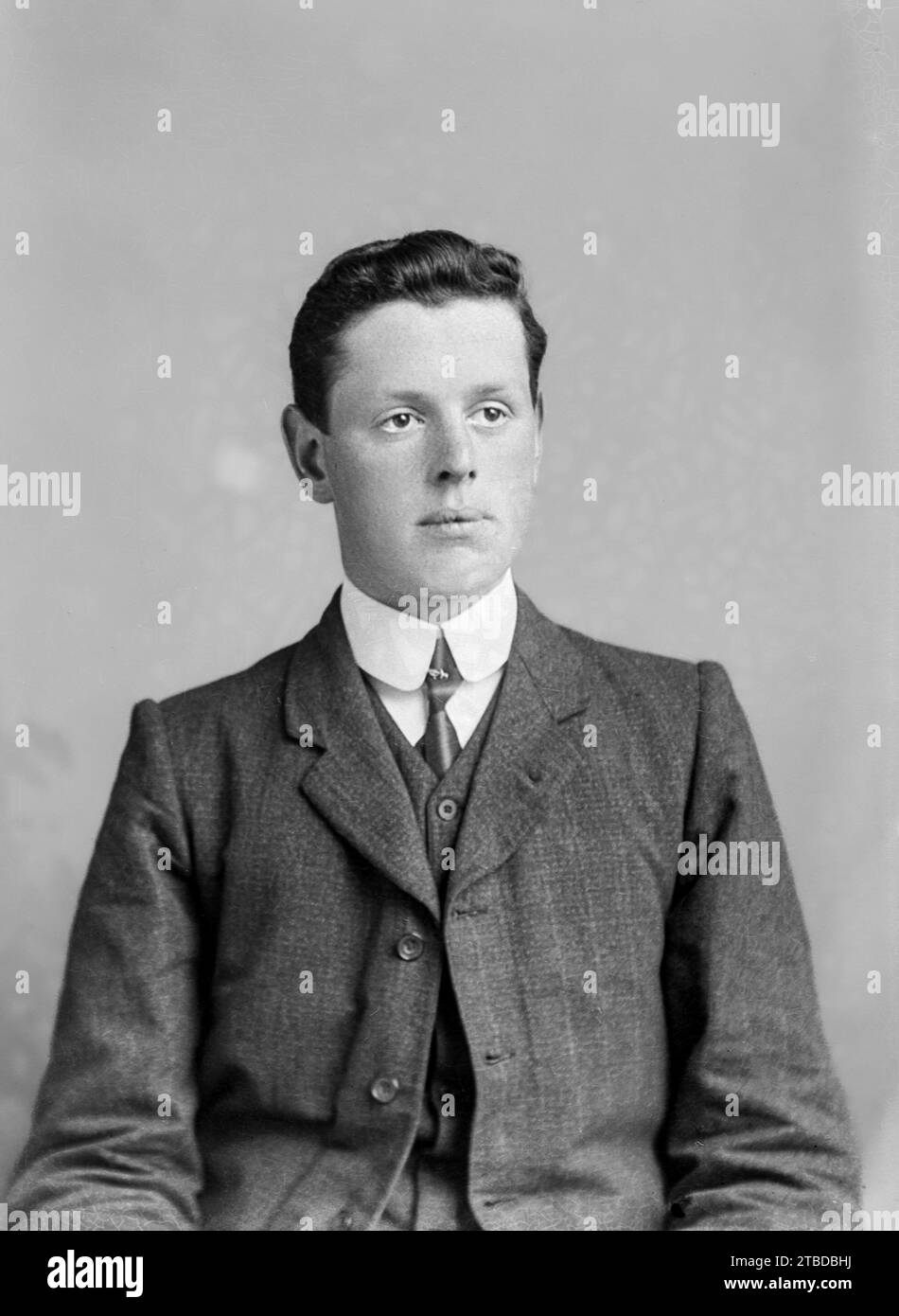 Edwardian formal portrait of a young man in a suit. Taken from a vintage glass plate negative.  C1900 - 1910 Stock Photo