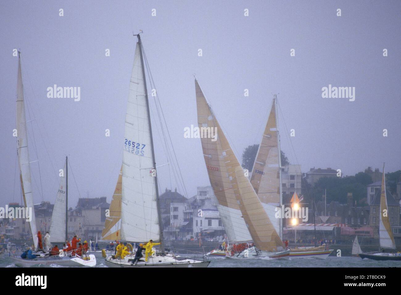 Cowes Sailing Regatta crews wait for the start of the racing, the two lights are to assist the yachts to identify the start line but don’t form the line. Cowes, Isle of Wight, England circa August 1985 1980s UK HOMER SYKES Stock Photo