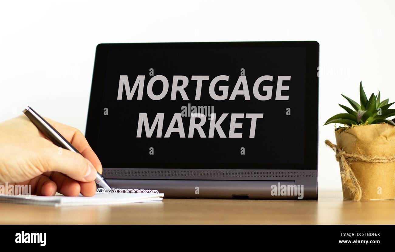 Mortgage market symbol. Concept words Mortgage market on beautiful black tablet. Beautiful white background. Businessman hand. Business mortgage marke Stock Photo