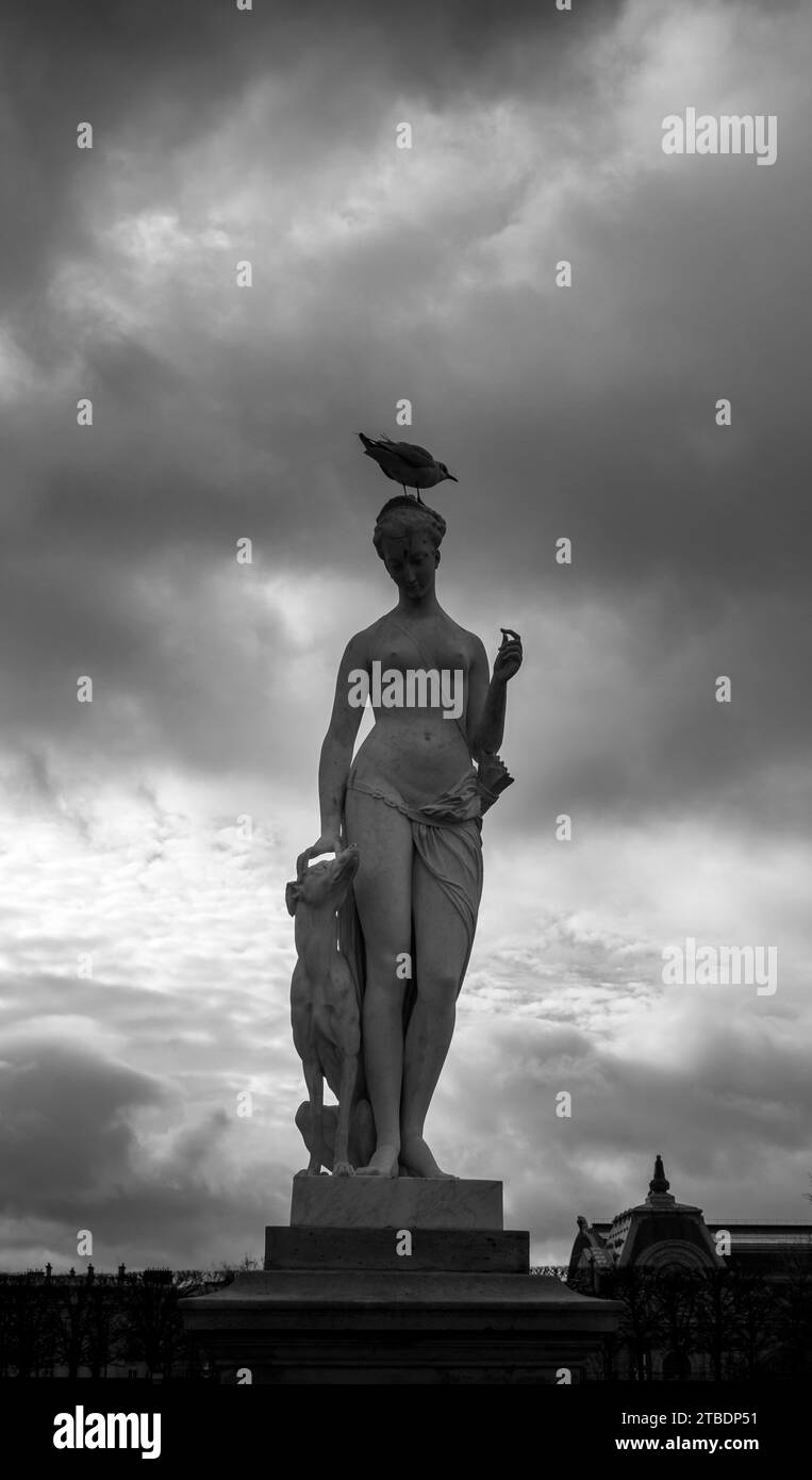 A bronze statue of a male figure with a bird perched atop its head