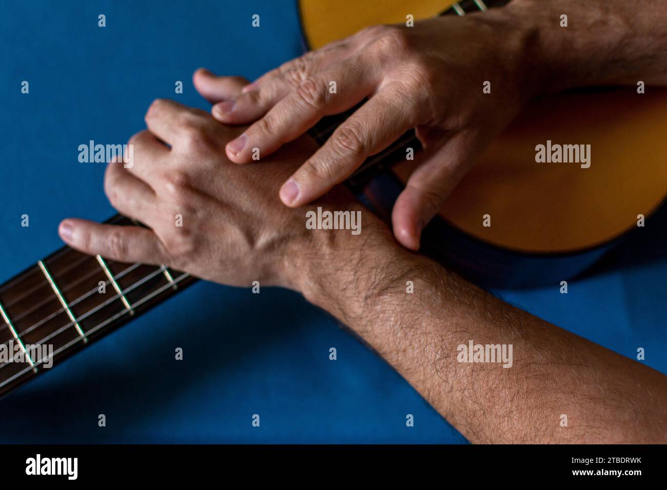 Hands on top of a classical guitar. Quality music Stock Photo