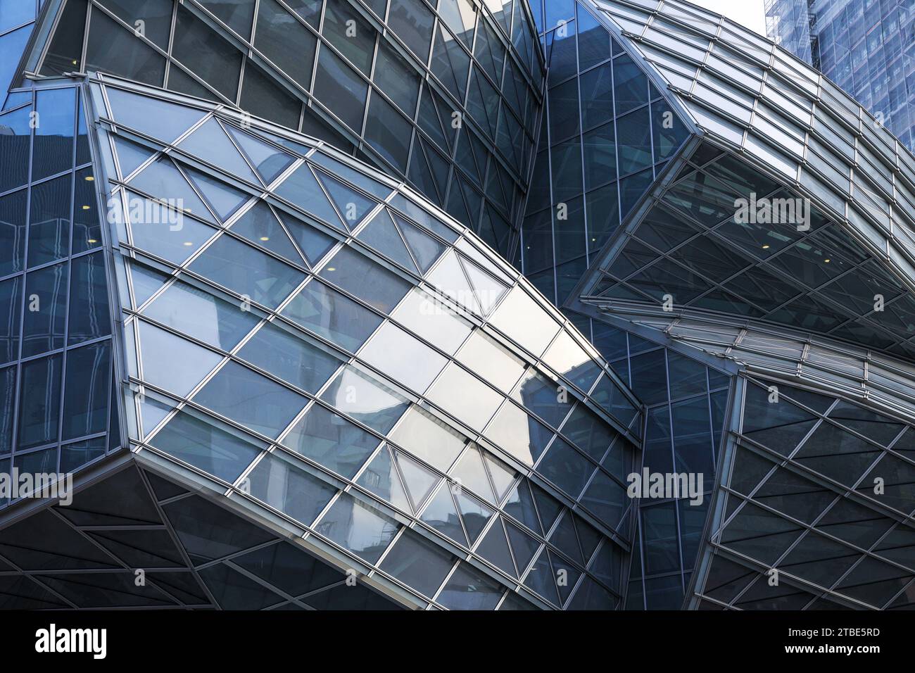 Basel, Switzerland - October 25 2022 : Details of the Gehry Building of Novartis Pharma AG. It was designed by Frank O. Gehry- a Futuristic glass and Stock Photo