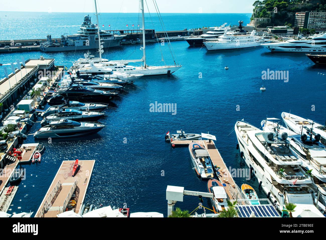 Amazing view on port Hercule of Monaco with large ocean sailboat with tall masts and huge motos yachts for rent and owned by rich people. Awe sunny re Stock Photo