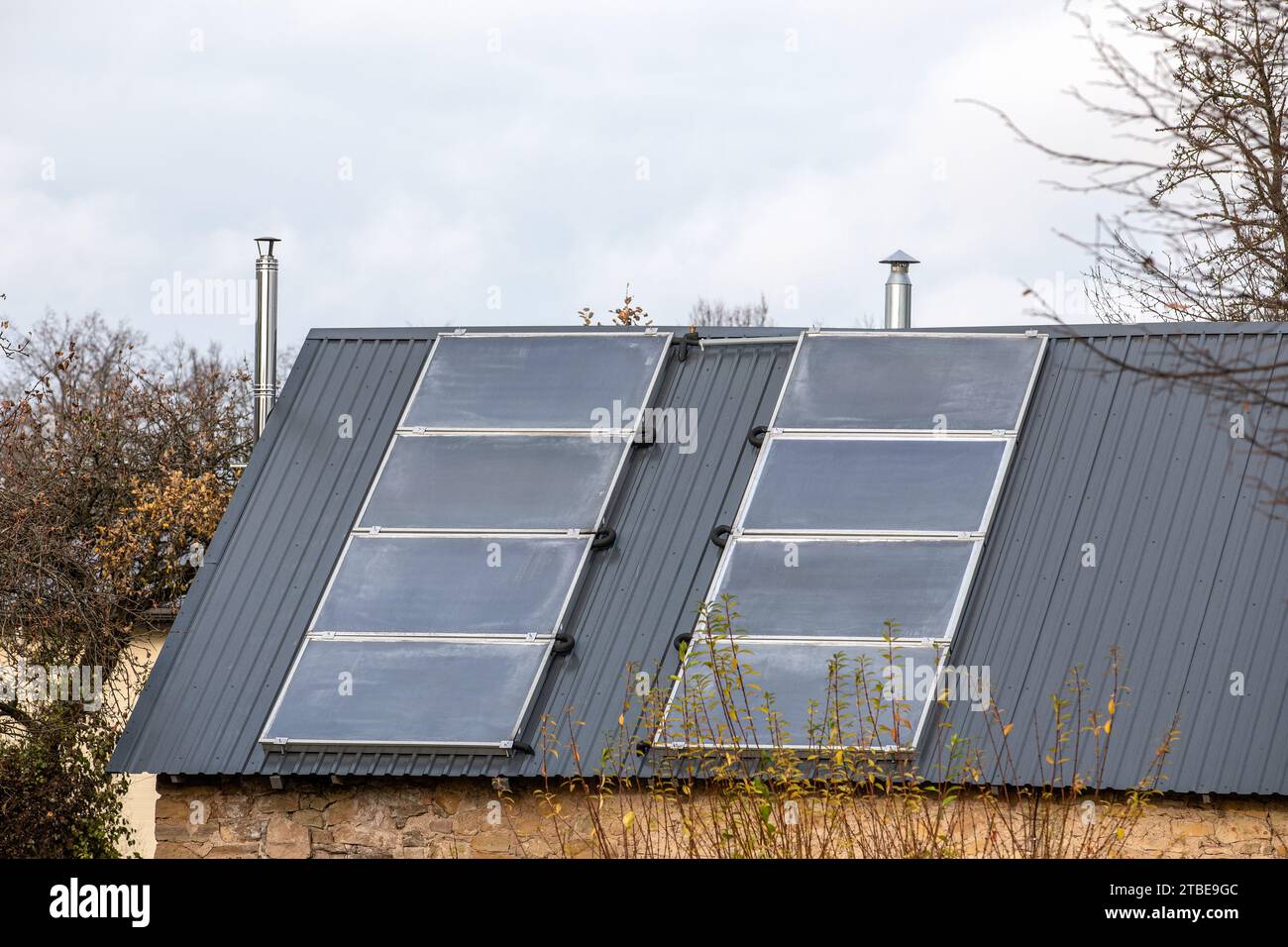 Solar Energy. Water solar collector on a metal roof Stock Photo - Alamy