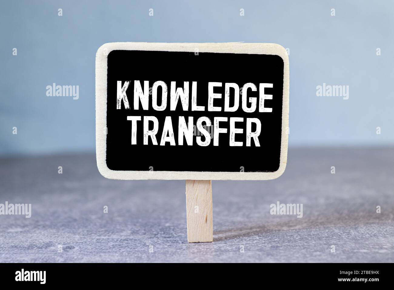 knowledge transfer. text on white paper on wood background. Stock Photo