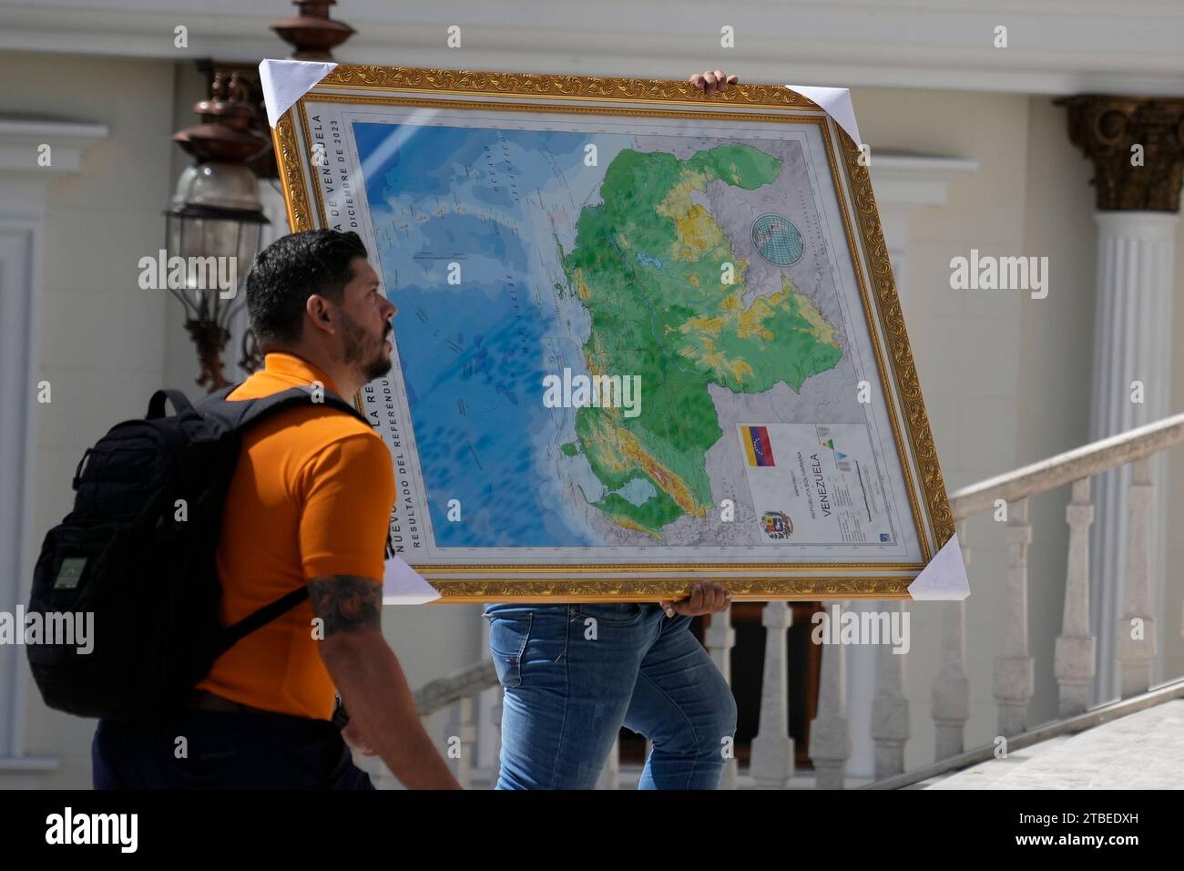 A man carries the new map of Venezuela with the Essequibo territory, a