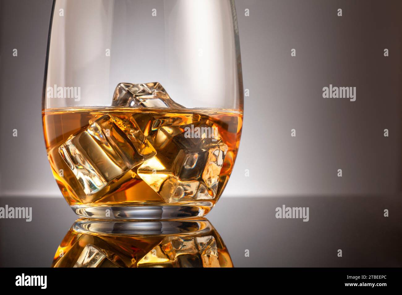 Glass of whisky with ice cubes Stock Photo