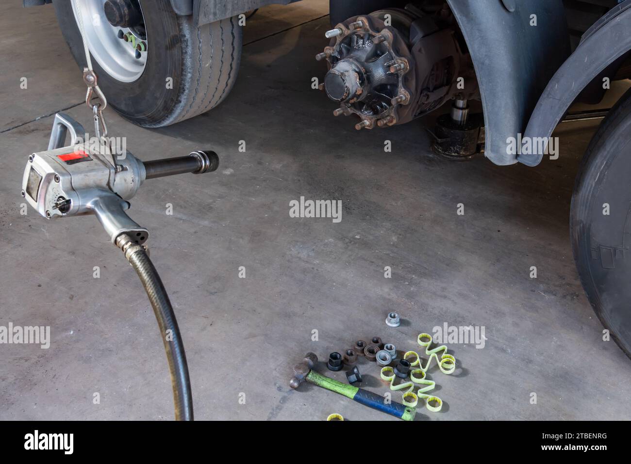 Compressed air tool to remove wheel bolts in a tire shop. Stock Photo