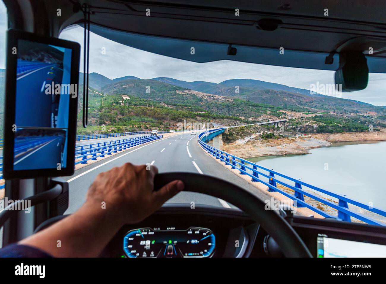 View from the driving position of a truck of a viaduct and a swamp below, vehicle . Stock Photo