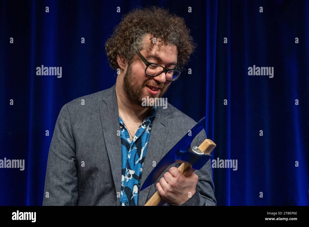 Passau, Germany. 07th Dec, 2023. David Stockenreitner, Austrian cabaret artist, holds the ScharfrichterBeil. The cabaret prize was awarded for the 40th time in Passau. It is aimed at up-and-coming artists and is one of the most prestigious cabaret prizes in the German-speaking world. Credit: Armin Weigel/dpa/Alamy Live News Stock Photo