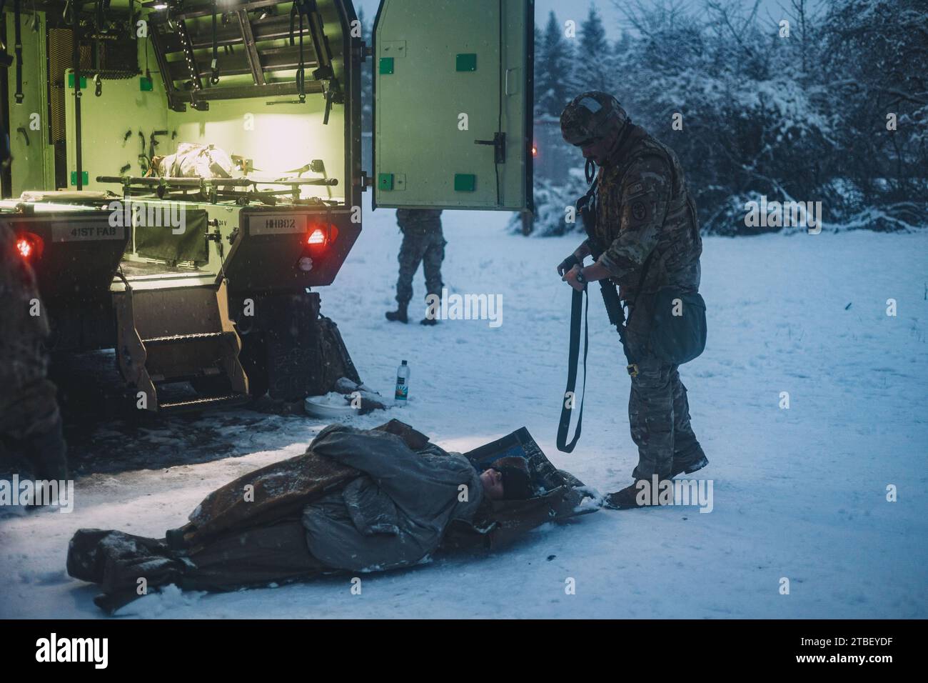 U.S. Army and multinational Soldiers conduct a casualty extraction during the day's continuous operations as part of the European Best Medic Competition (EBMC) in Grafenwoehr, Germany, Dec. 6, 2023. The EBMC will test the physical fitness, medical skills, and readiness of European theater medics' ability to perform technical tasks to standards of excellence in a broad spectrum of critical individual and team skills during combat operations. The highest winners of U.S. forces are selected to represent the European region at the Army Best Medic Competition at Fort Liberty, North Carolina. (U.S. Stock Photo