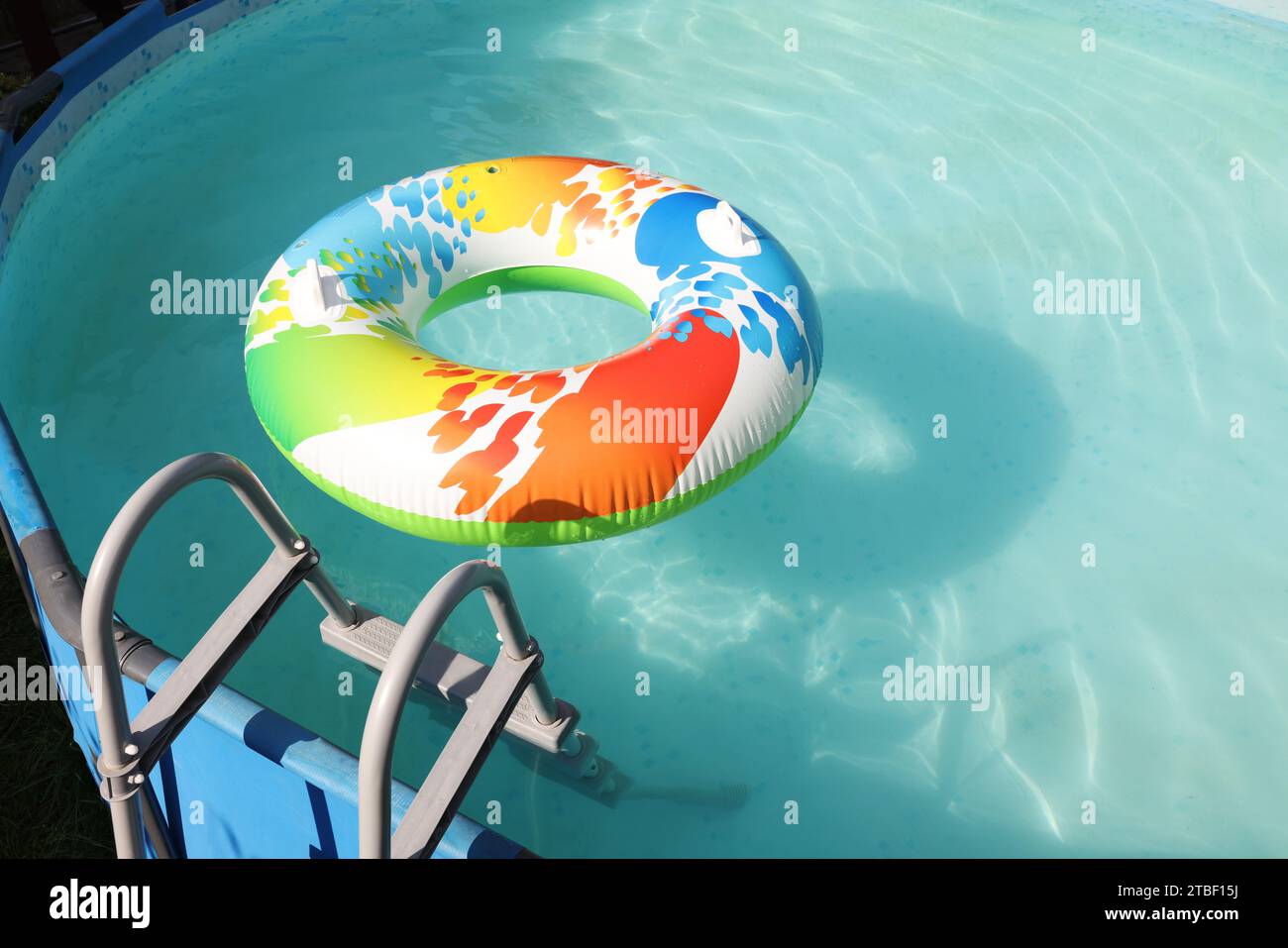 Inflatable ring floating on water in above ground swimming pool ...