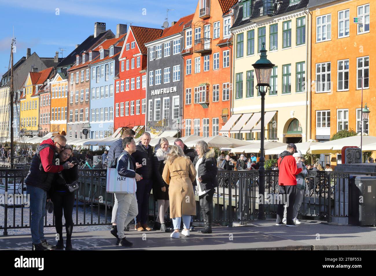Denmark In October Copenhagen, Denmark - October 22, 2023: People on the bridge of Nyhavn ...