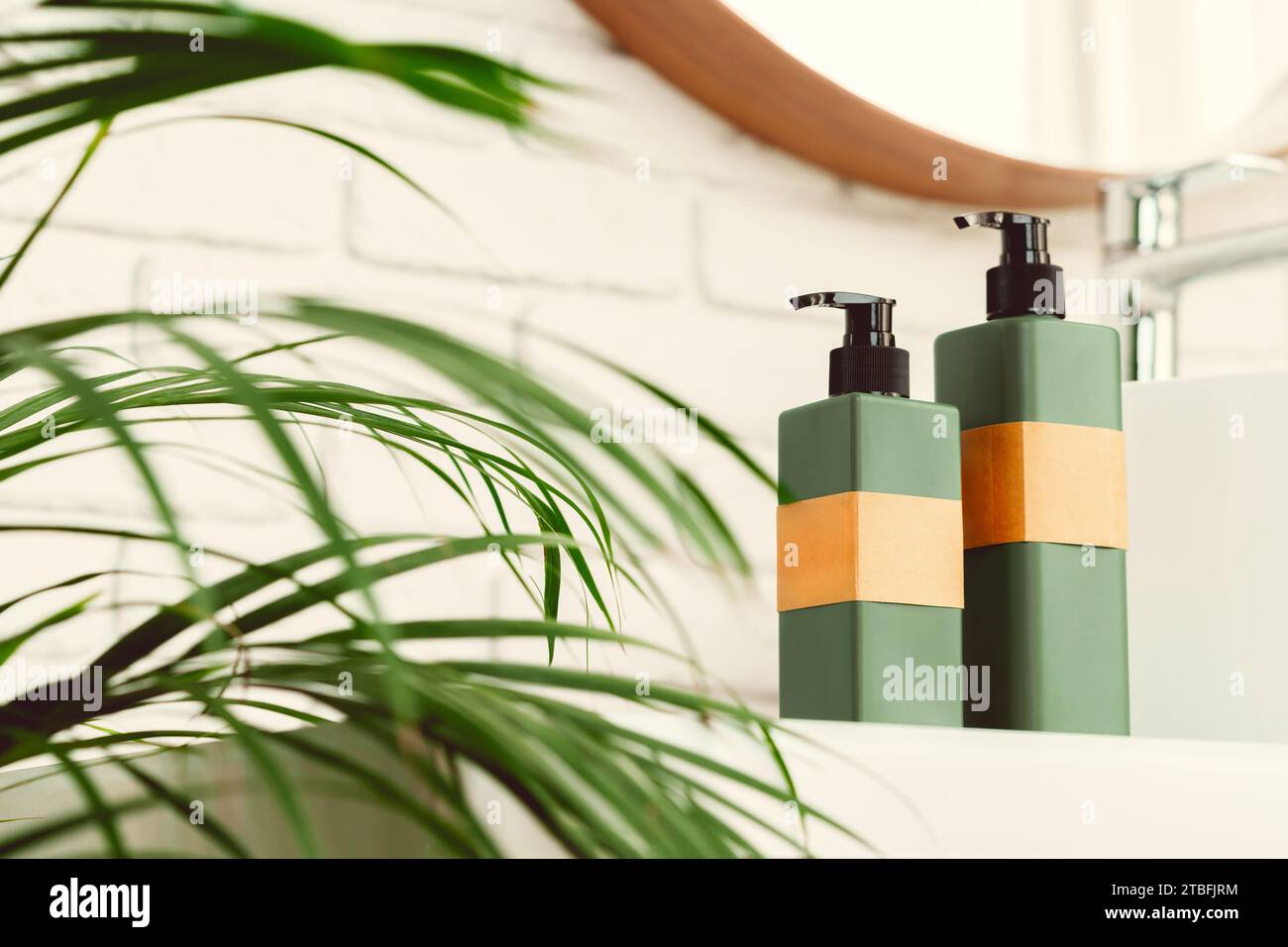 Soap and cream dispenser jars near the sink in a bathroom Stock Photo ...