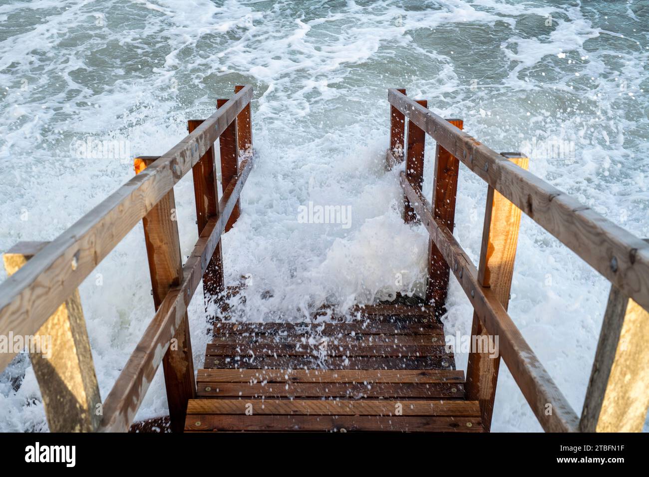 Wooden steps leading down to Findhorn beach at high tide. Morayshire, Scotland Stock Photo