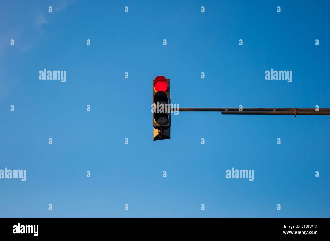 Traffic light showing red with blue sky background Stock Photo - Alamy