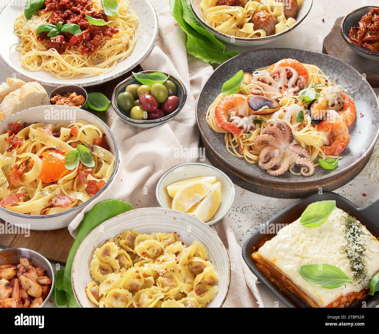 Assortment of Italian pasta dishes on light bachground. Traditional food concept. Stock Photo