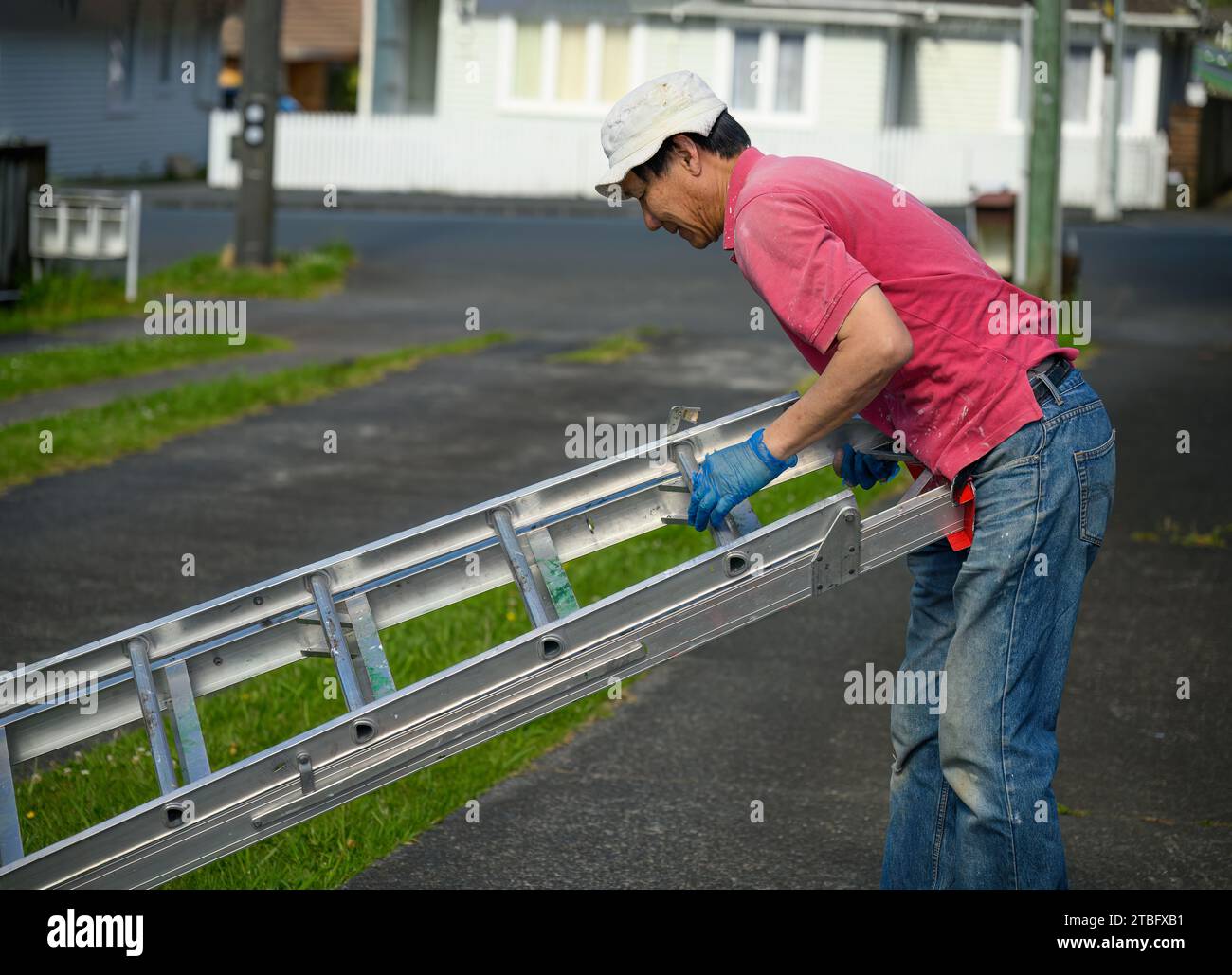 Man folding the ladder after finishing work. Home maintenance work