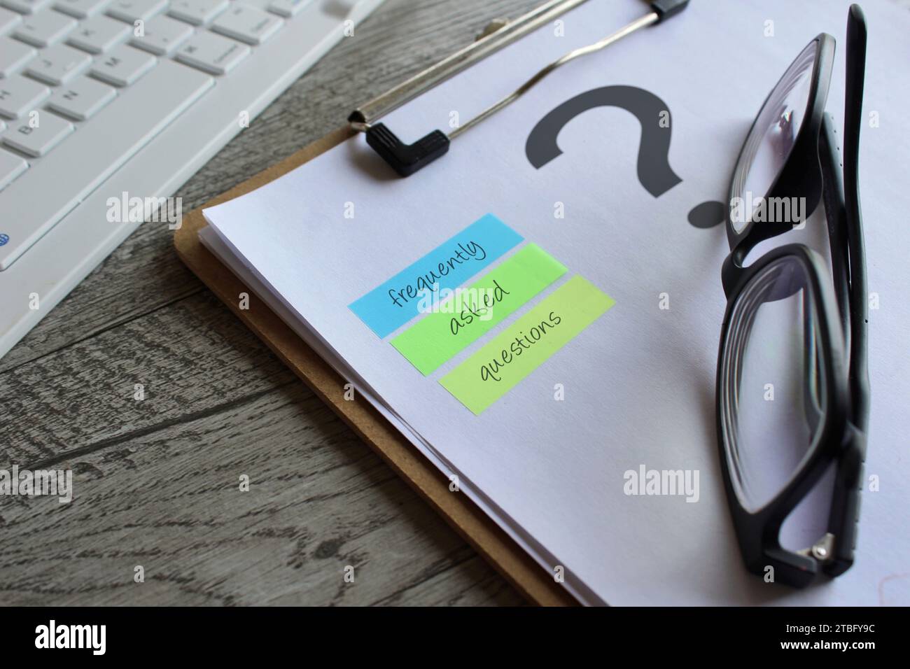 Close image of paper clipboard with question mark and text FREQUENTLY