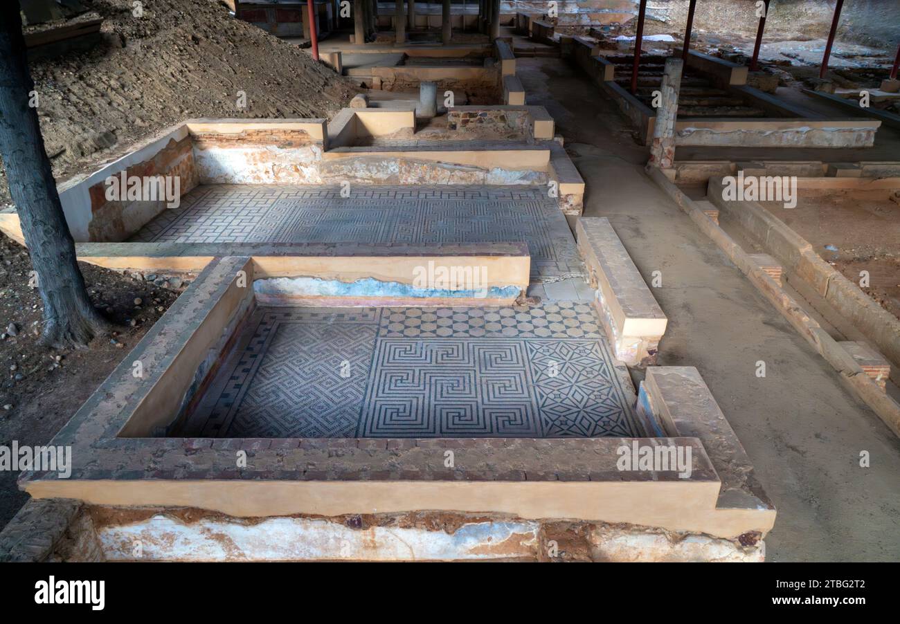 Archaeological remains of the floors of different Roman rooms with the floor decorated with mosaics with blue geometric figures that create a fractal Stock Photo