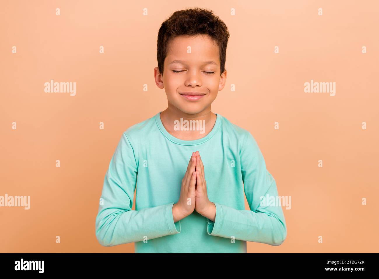 Photo of charming cute dreamy boy closed eyes asking for peace ...
