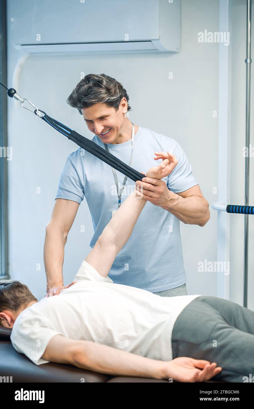 Arm hyperextension. ale young patient having a session of arm