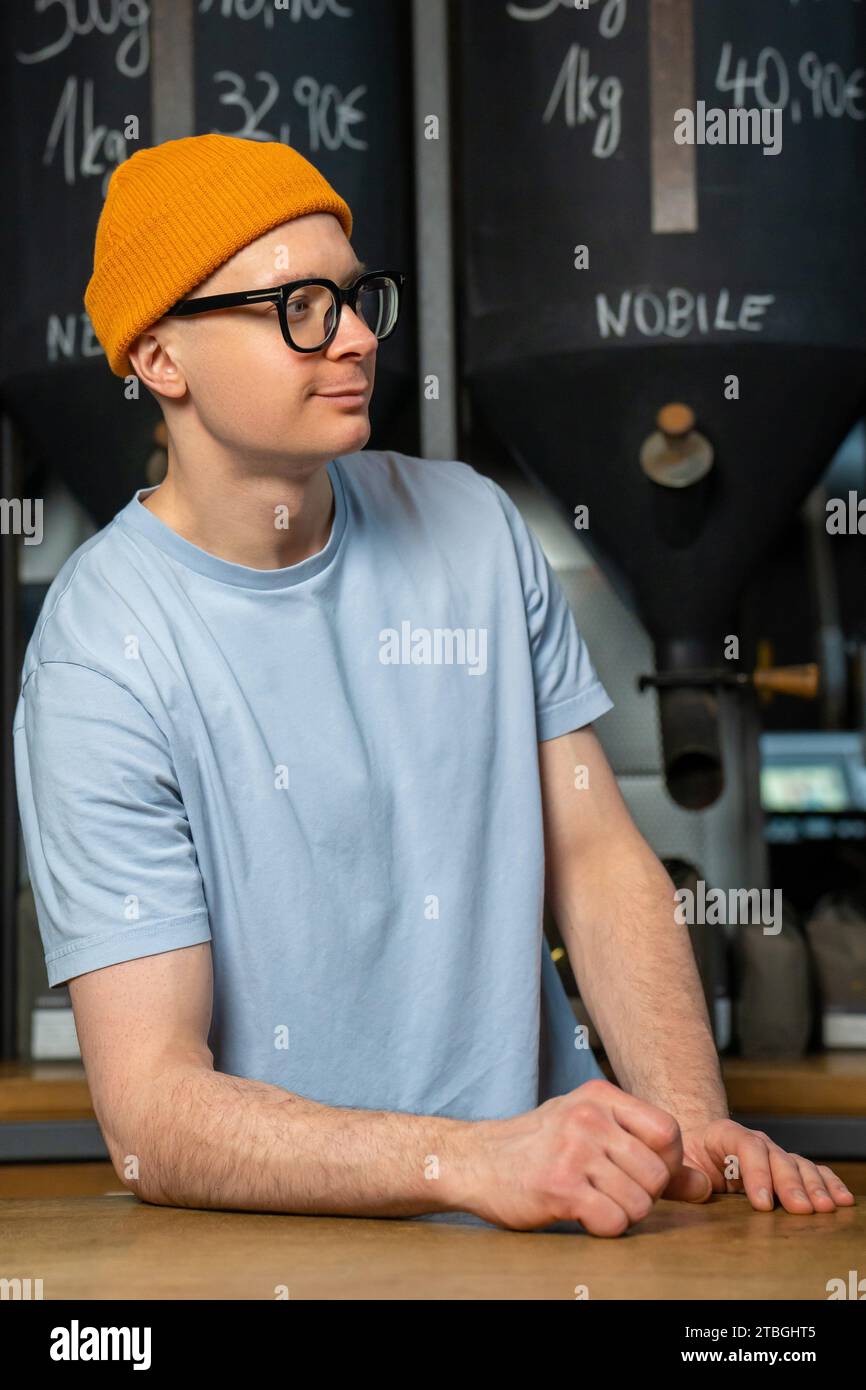 Handsome hipster bartender wearing beanie hat and glasses in the
