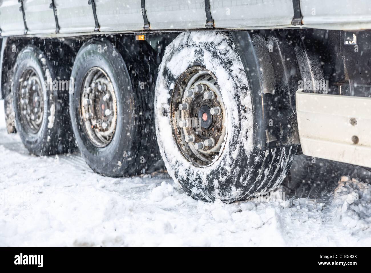 Stuck truck semitrailer in snow during heavy snowfall on a snowy road