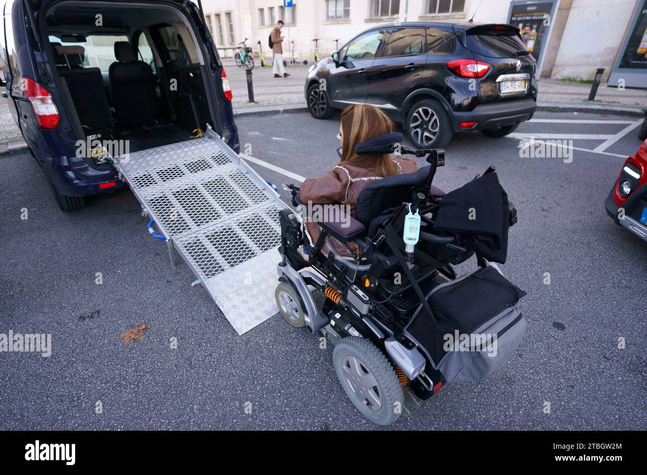 Handicapped person getting into a custom made adapted vehicle Stock Photo