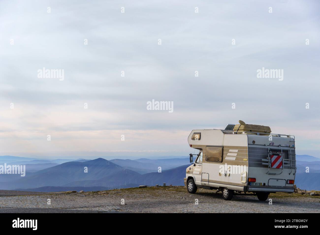 Motorhome RV parked in front of a mountain landscape Stock Photo