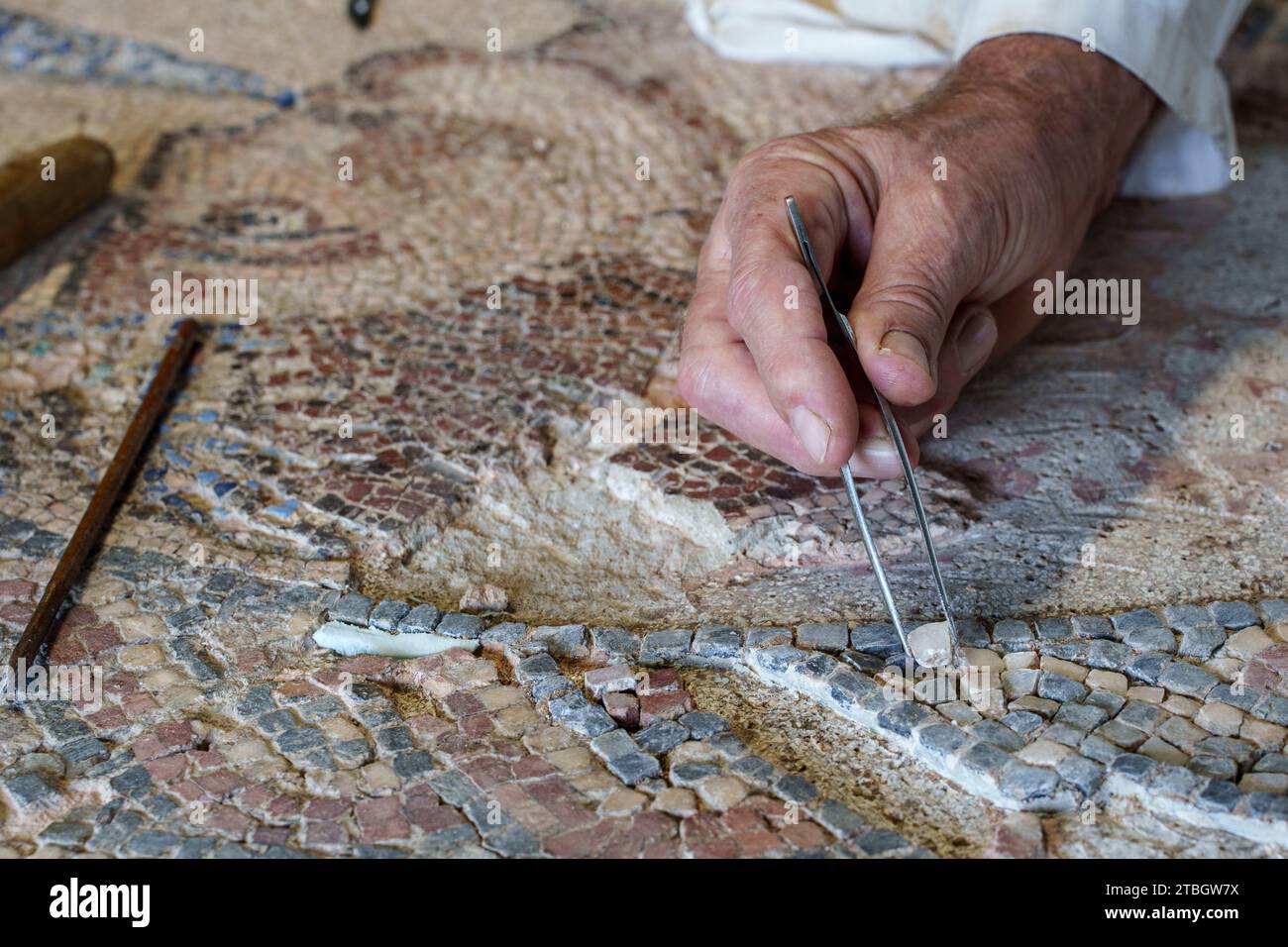 Person restoring Roman mosaic in Conimbriga, Portugal, Europe Stock ...