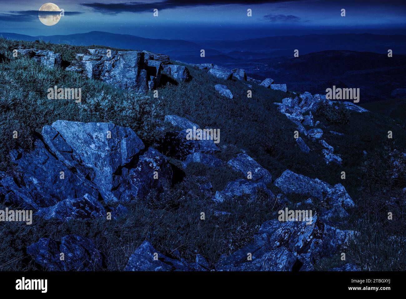 sharp stones on the hillside in mountain landscape at night. mysterious ...