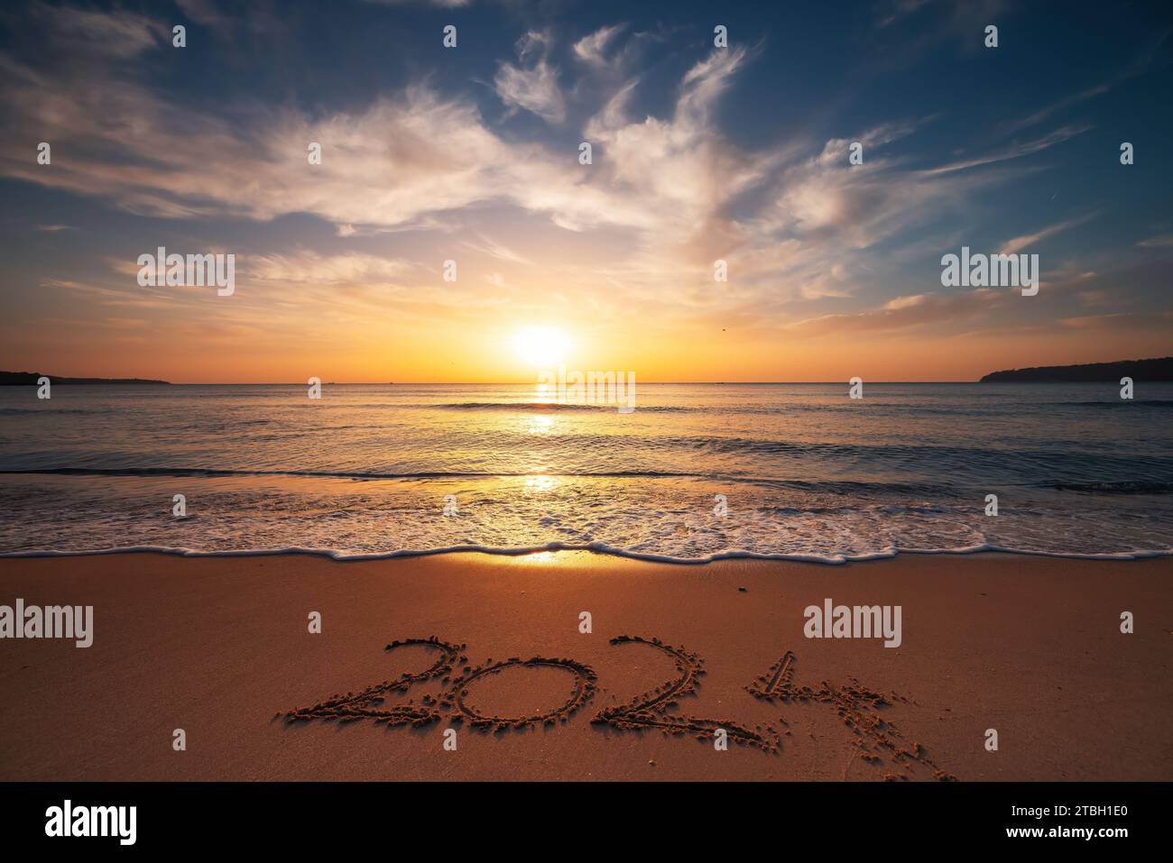 Happy New Year 2024 concept, lettering on the beach. Written text on