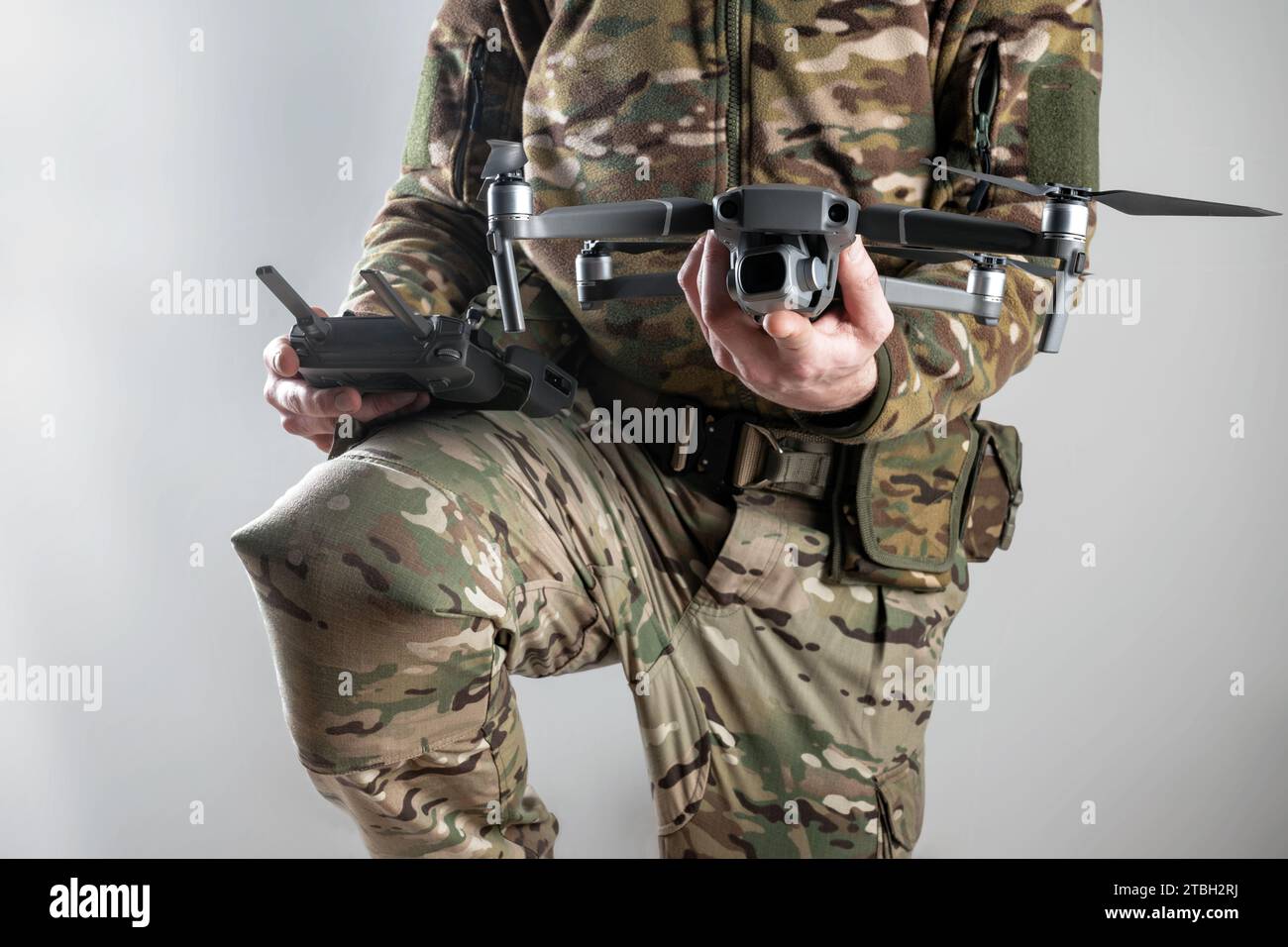 Modern army soldier with a remote control and drone prepares to fly