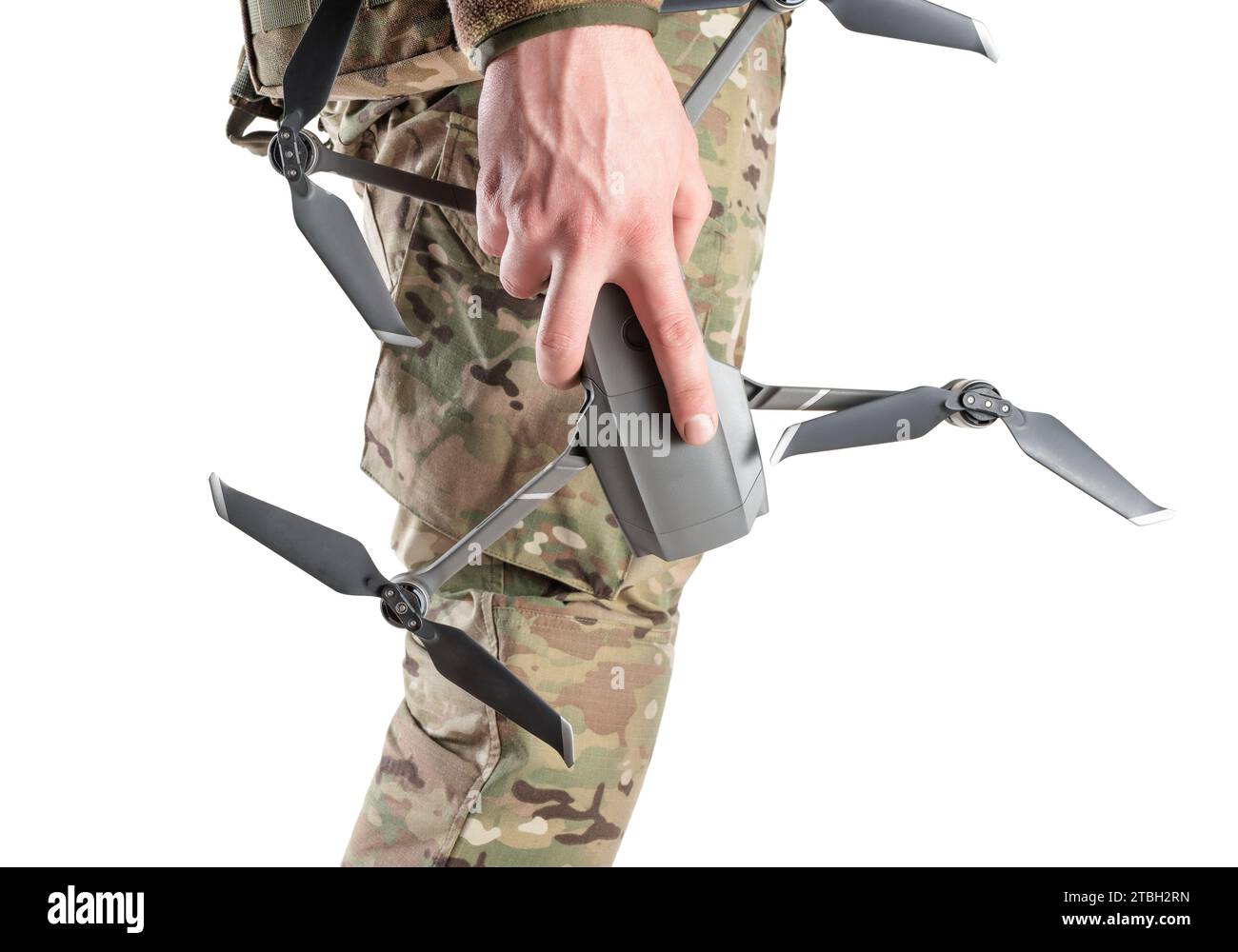 Drone in hand of military soldier in camouflage uniform. Side view on a white background. Concept of drones in modern war. Stock Photo