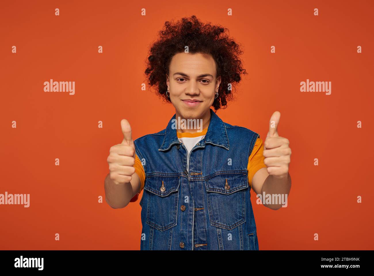 handsome young african american man in casual urban outfit posing ...