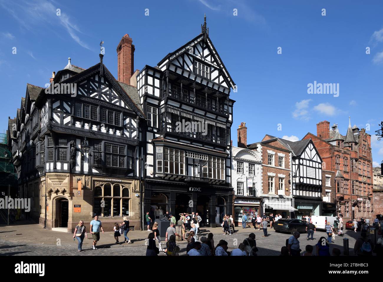 Tourists & Shoppers Eastgate Street Chester Old Town or Historic District England UK including Victorian Tudor Style Corner Buildings Nos 35 & 37. Stock Photo