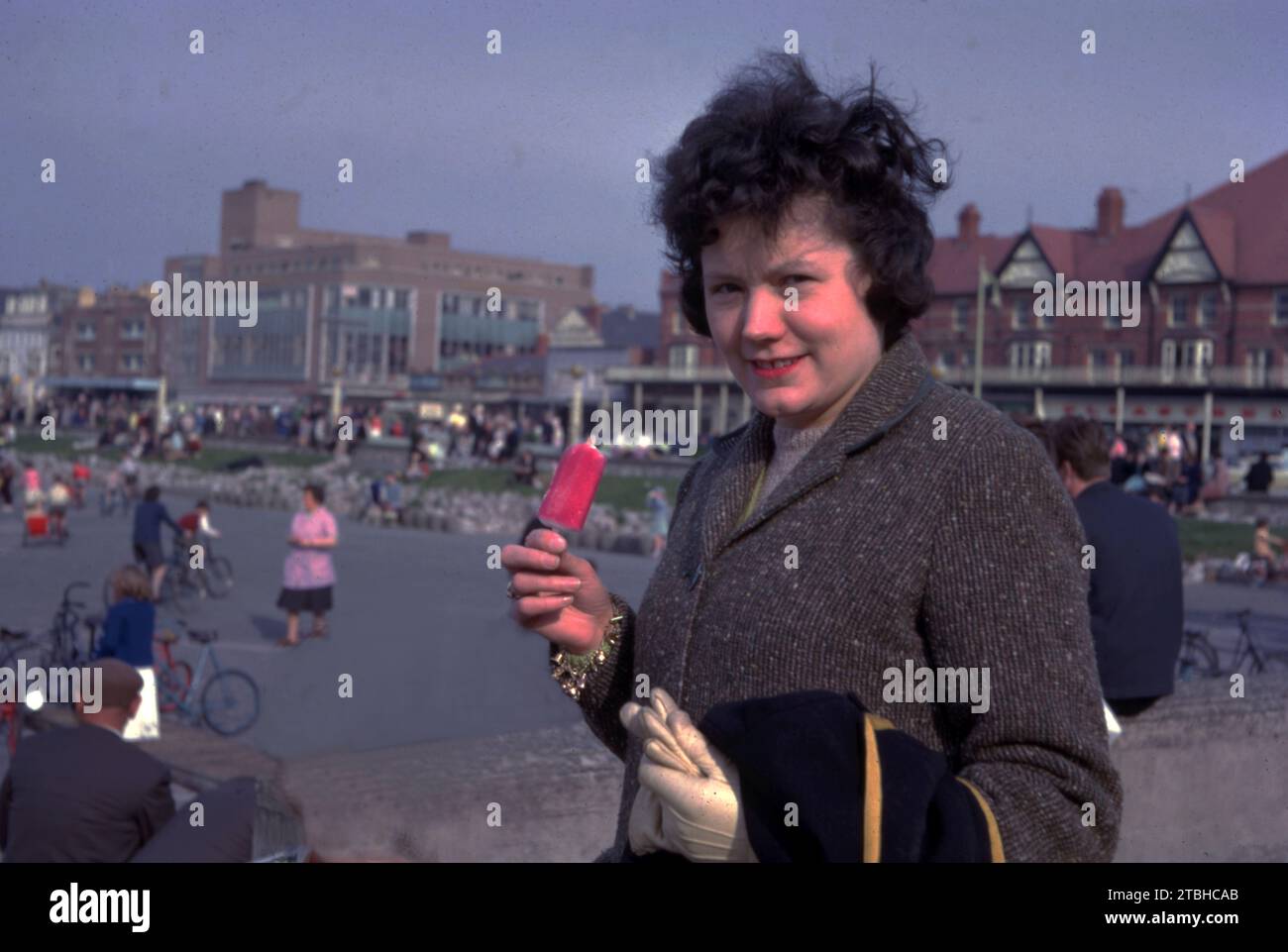 A young woman enjoying a strawberry Mivvi iced lolly c1962   Photo by Tony Henshaw Archive Stock Photo