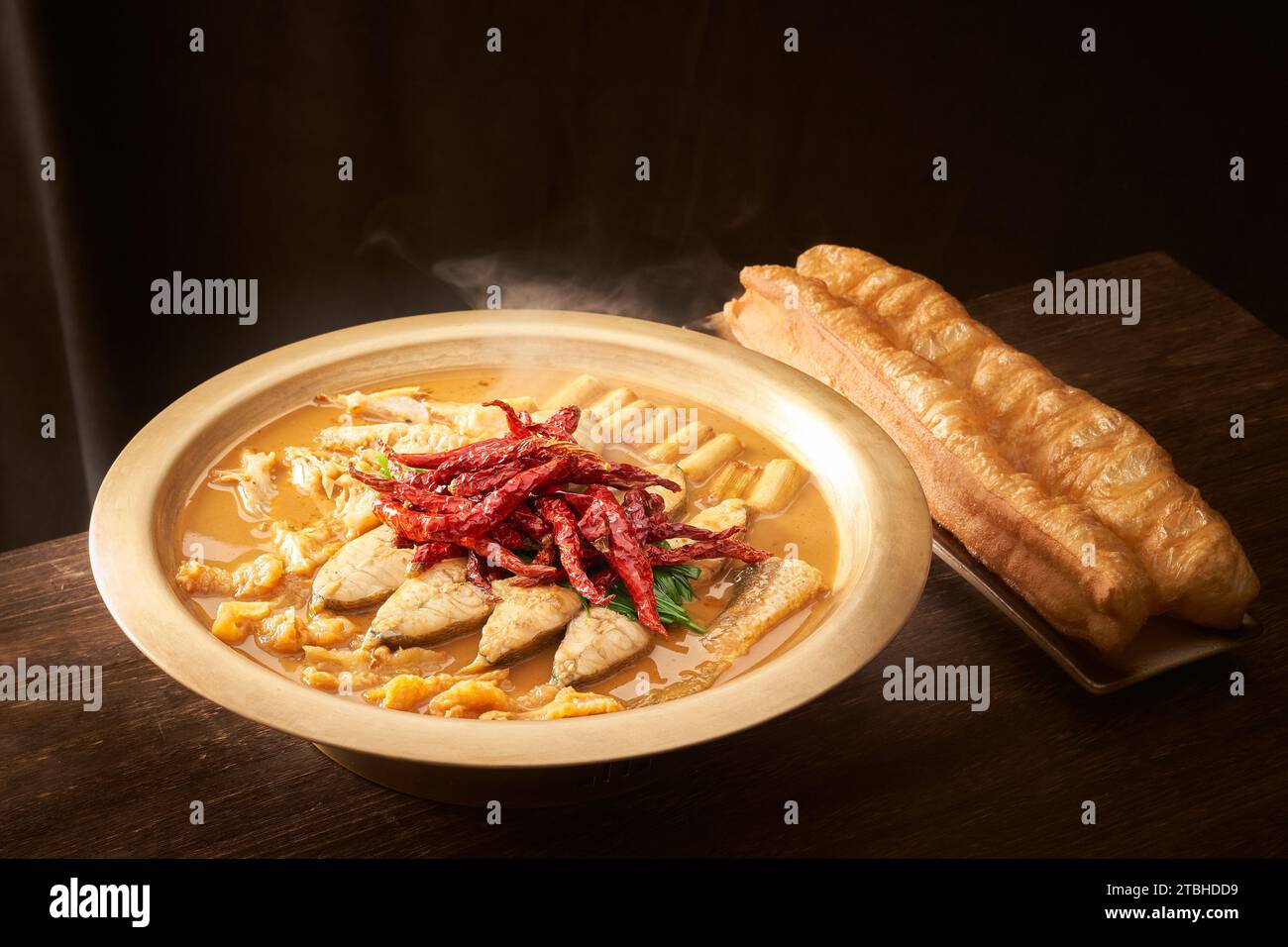 Stewed Carp fish head in Brown Sauce served with Deep Fried Dough Stick Stock Photo