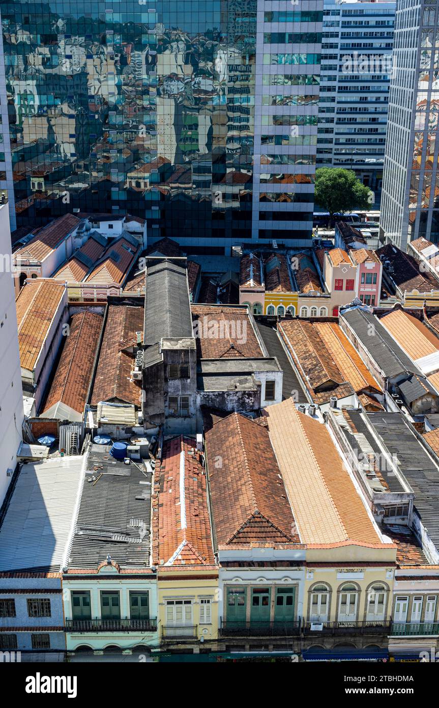 Urban contrast - preserved sobrados, two or more story ancient houses from the colonial and imperial periods in Brazil at the heart of the popular commerce region known as Saara in downtown Rio de Janeiro, next to corporate modern buildings. Stock Photo