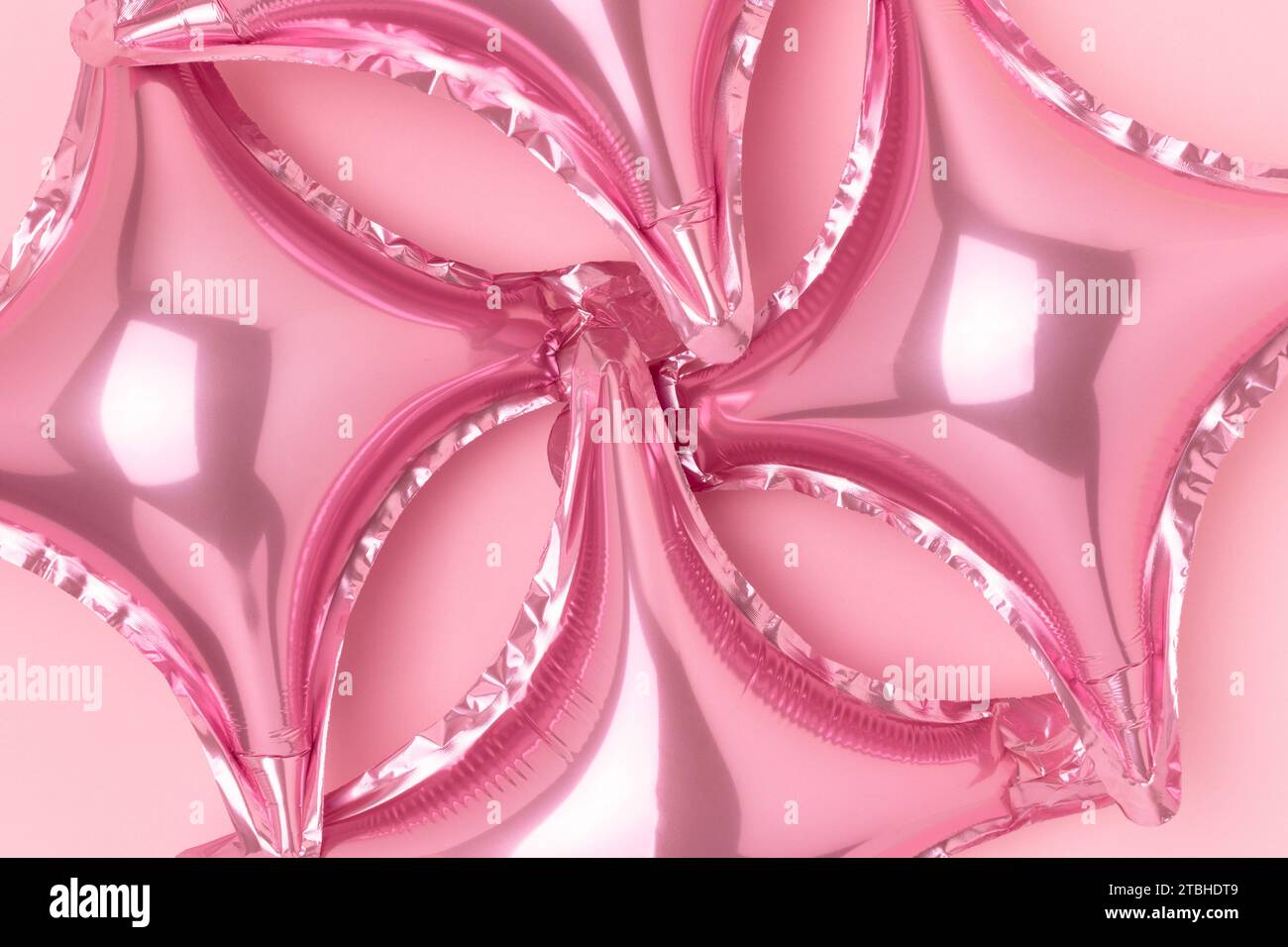 Texture made of inflatable star balloons on a pink background ...