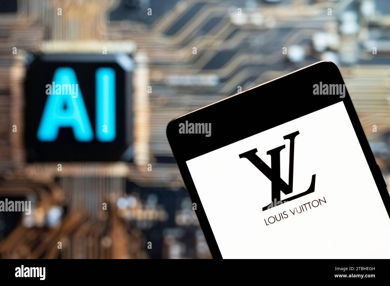 Hong Kong, China. 03rd Nov, 2023. In this photo illustration, the French luxury fashion brand Louis Vuitton (LV) logo seen displayed on a smartphone with an Artificial intelligence (AI) chip and symbol in the background. (Photo by Budrul Chukrut/SOPA Images/Sipa USA) *** Strictly for editorial news purposes only *** Credit: Sipa USA/Alamy Live News Stock Photo