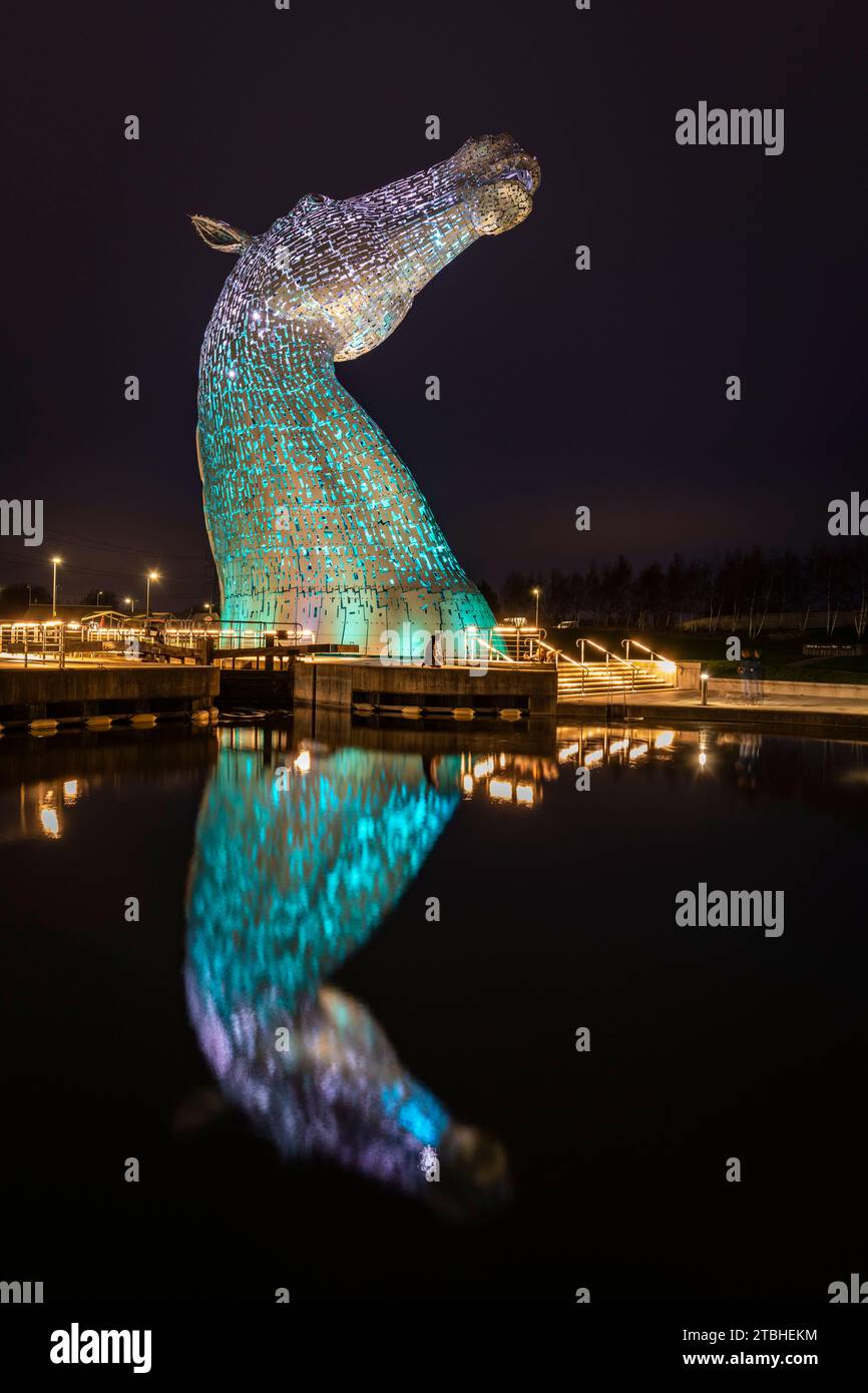 The Kelpies sculpture illuminated at night in Helix Park near Falkirk