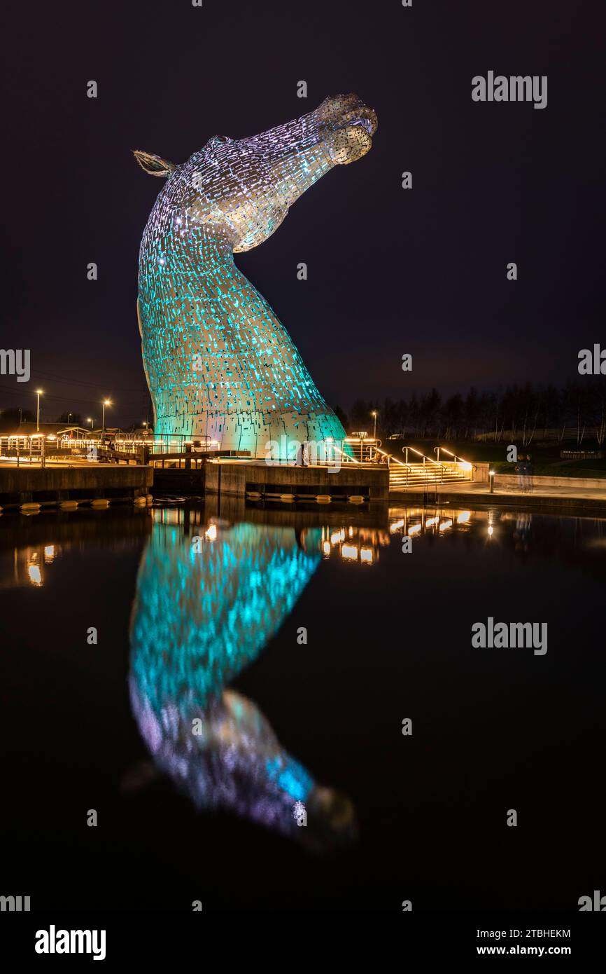 The Kelpies sculpture illuminated at night in Helix Park near Falkirk, Scotland.  Spring (March) 2023. Stock Photo
