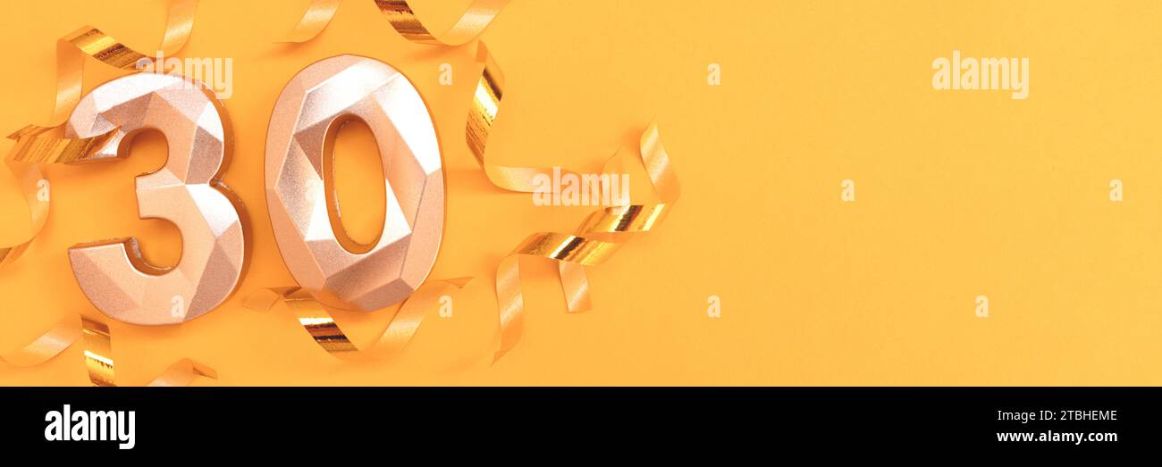 Banner with golden number 30 and ribbons on a yellow background. Stock Photo