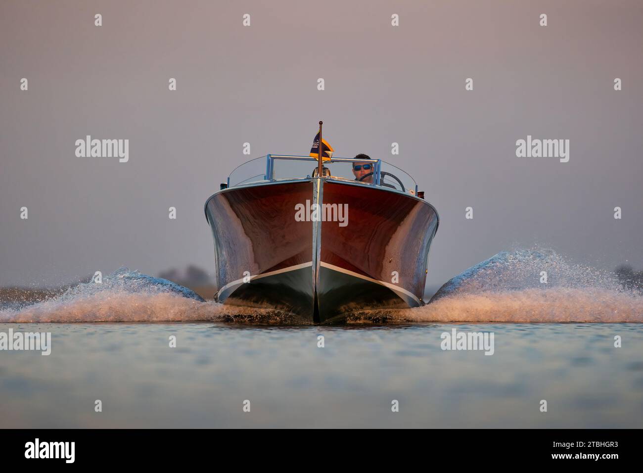 Classic wood speedboat approaching headon at high speed Stock Photo