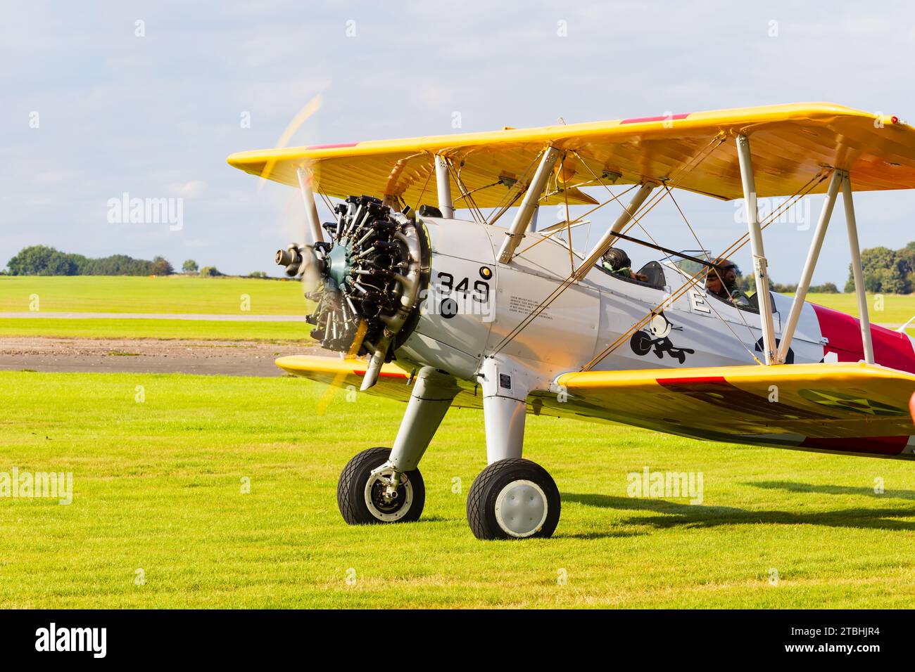 Vintage Boeing Stearman Kaydet 2 seat military bi plane trainer of the US Navy, taking off from RAF Syerston, Nottinghamshire. Stock Photo