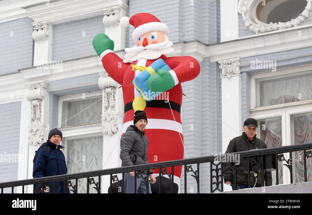KYIV, UKRAINE DECEMBER 6, 2023 Workers install an inflatable Santa